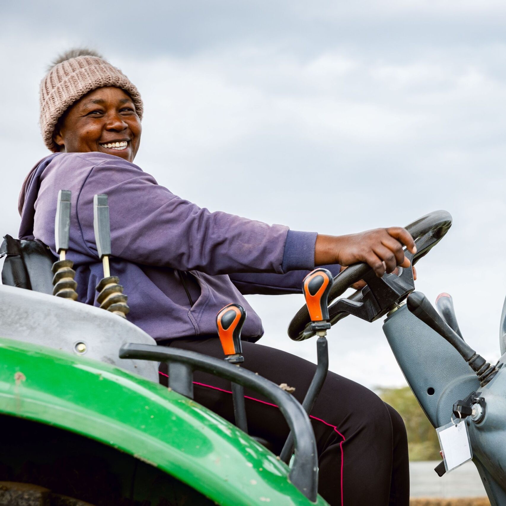 Farmer smiling while driving equipment